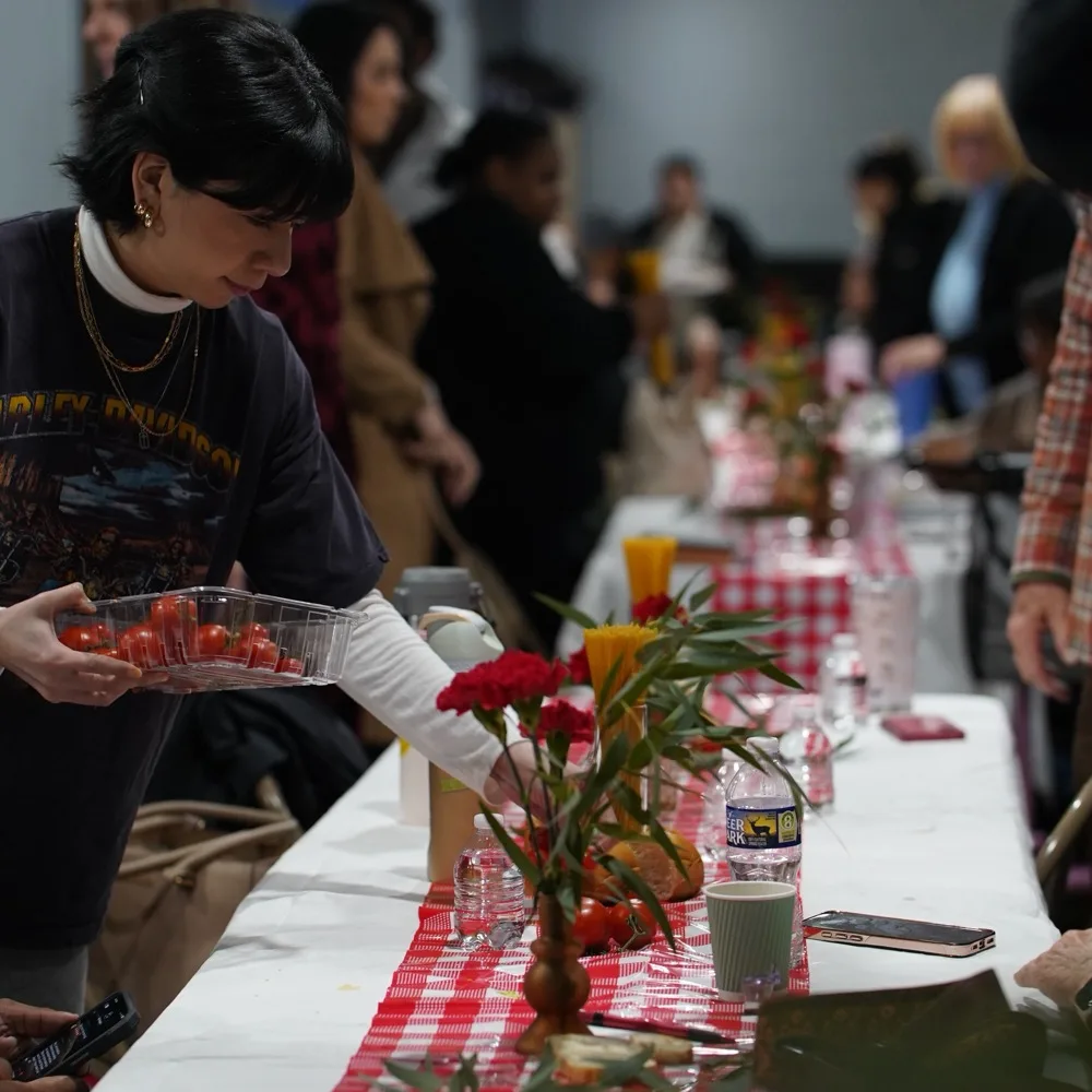 Setting a long shared table at a Garden Co. dinner