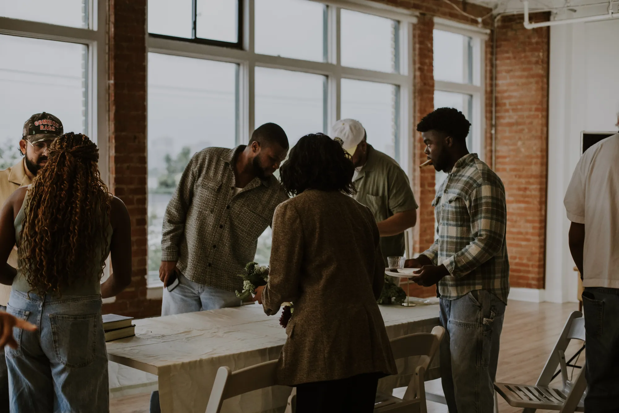 People gathered around a long wooden table