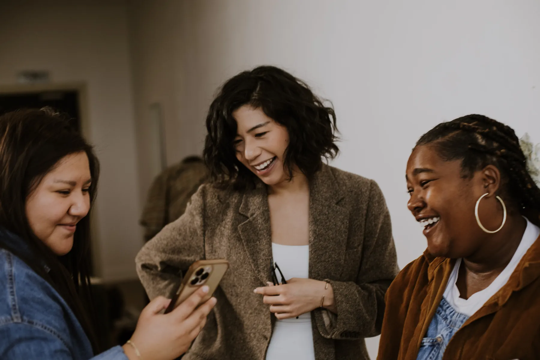 Three women laughing together
