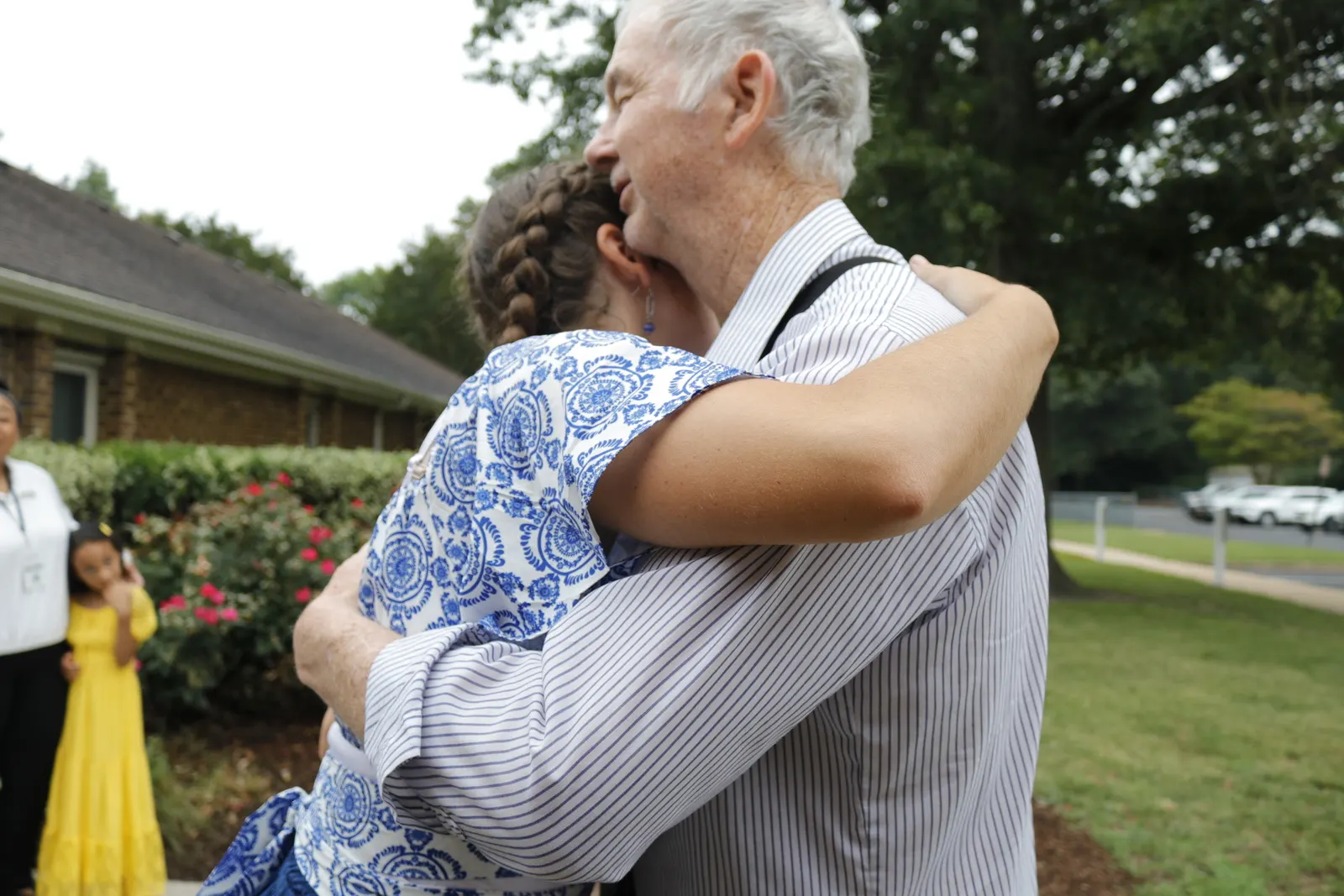 A greeting hug outside the front door