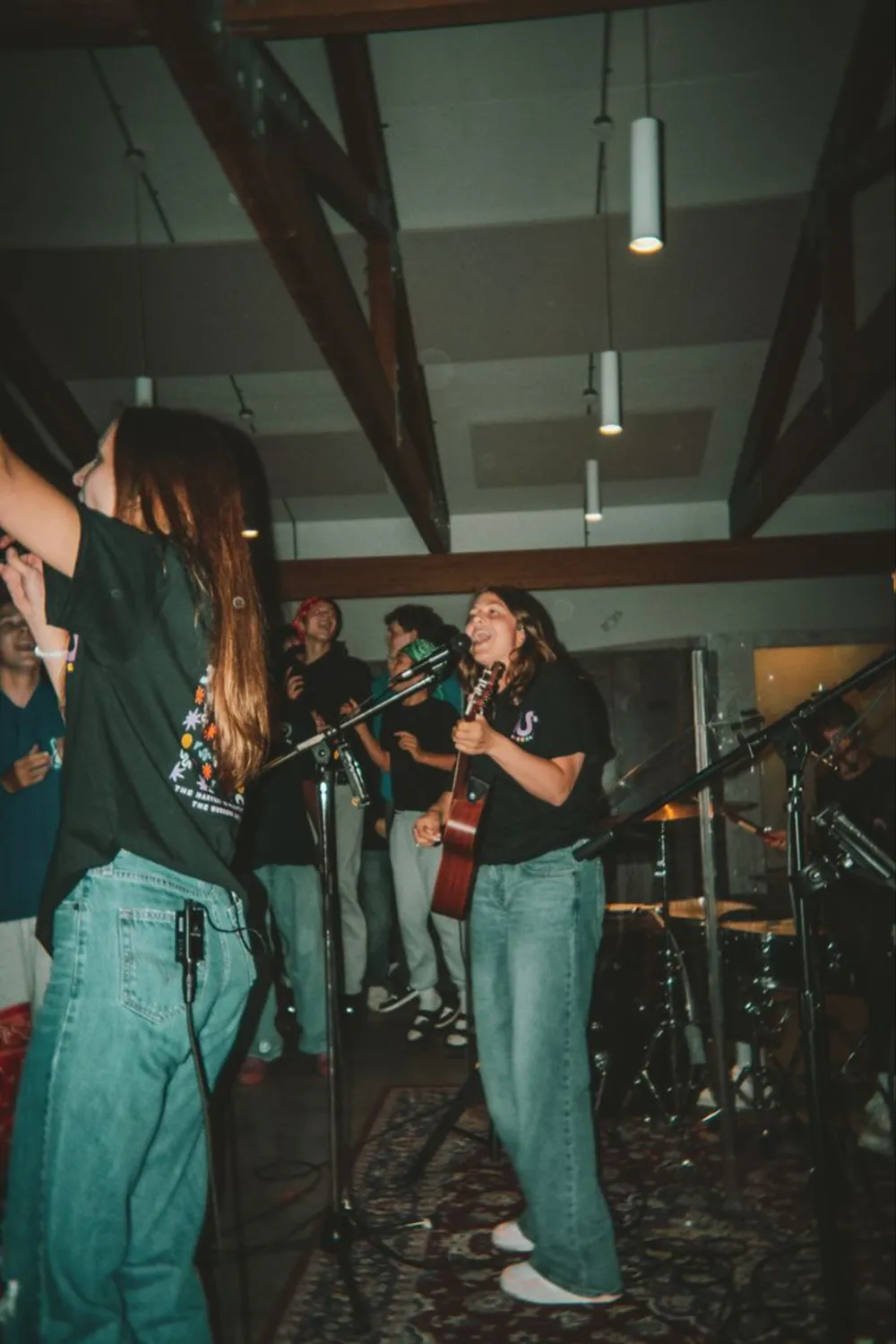 Students singing with a band at a youth night